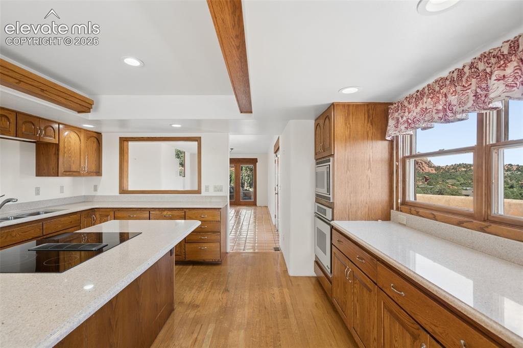 Image 27 of 46: The kitchen opens naturally into the surrounding living spaces, keeping the