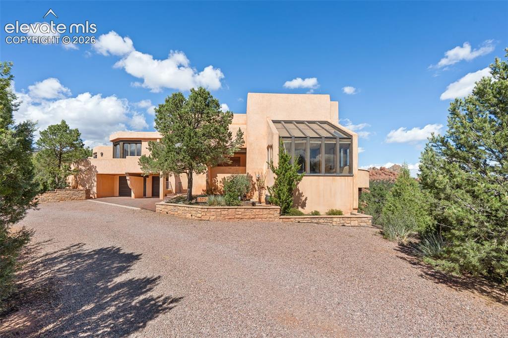 Image 3 of 46: Distinctive Southwestern architecture complements a setting where red rock,