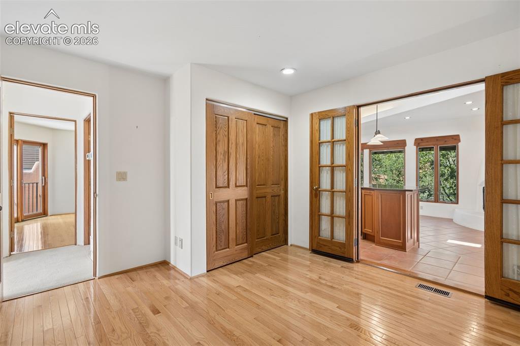 Image 32 of 46: A flexible main level room offers options for a third bedroom, home office,