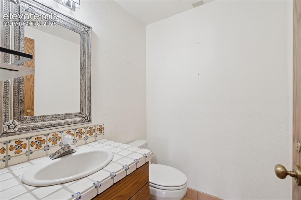 Image 36 of 46: A conveniently located powder room provides an additional main level bath f