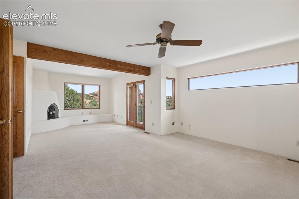 Image 39 of 46: A wood burning fireplace creates a cozy focal point within the spacious pri