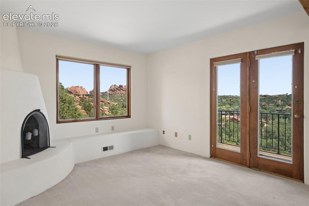 Image 41 of 46: Windows on multiple sides fill the primary suite with natural light and eve