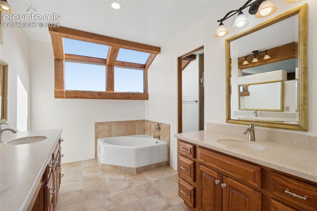 Image 45 of 46: Dual vanities provide function and space within the primary bath.