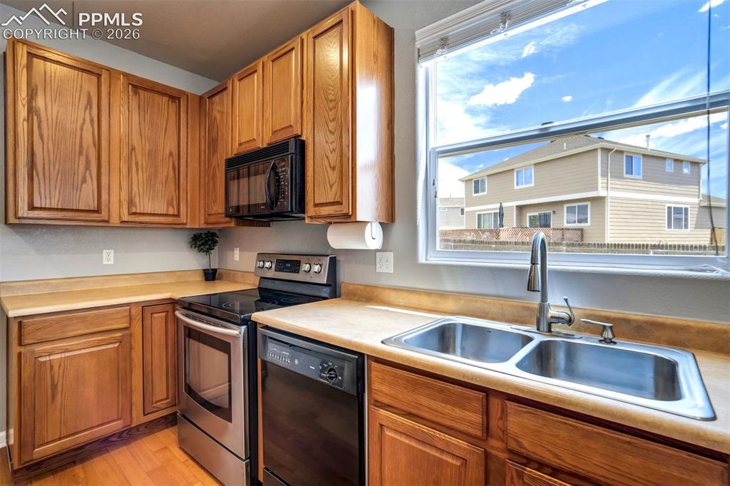Image 14 of 48: Sink above the kitchen looking to the backyard 