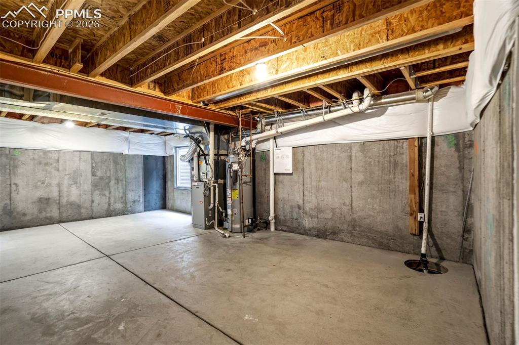 Image 39 of 48: Sump pit and pump in unfinished basement