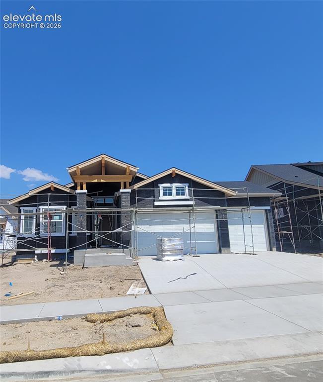 Image 1 of 21: Falkirk-Ranch Plan-Craftsman Elevation-3 Car Garage! Please, excuse our dus