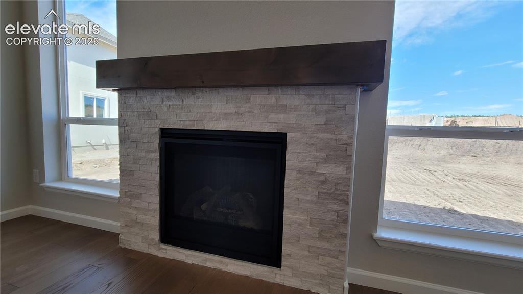 Image 13 of 47: Gas Fireplace with stacked stone surround and a wood mantel!