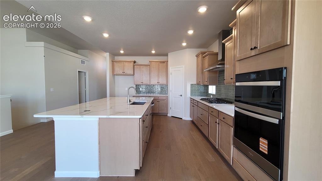 Image 6 of 47: Gourmet Kitchen with quartz countertops, pantry, huge island providing addi
