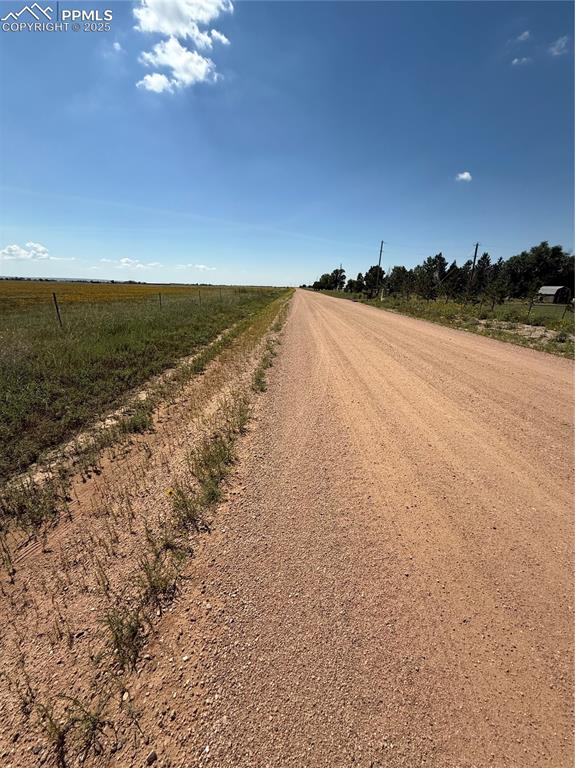 Image 4 of 4: View of dirt / gravel road with a rural view