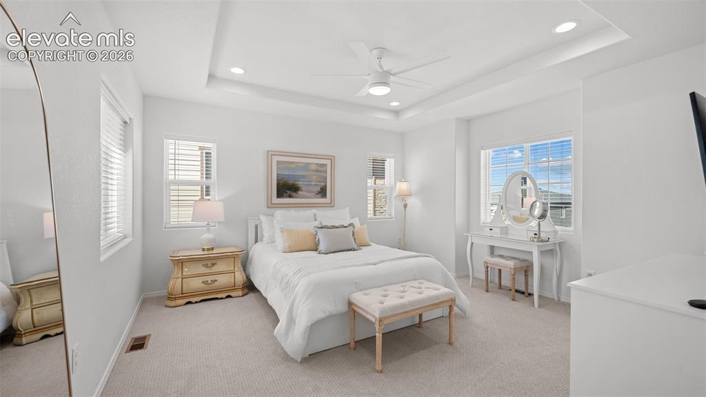 Image 20 of 38: Carpeted room featuring a tray ceiling with recessed lighting and a ceiling