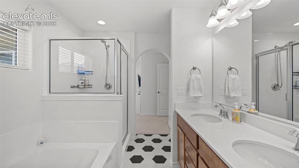 Image 24 of 38: Bathroom featuring a dual vanity with white countertops, a large framed mir