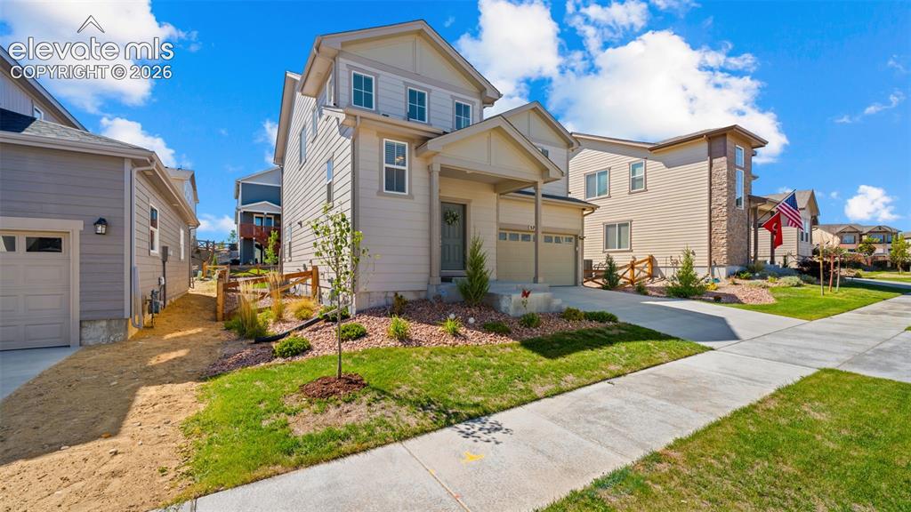 Image 3 of 38: Contemporary two-story residence with a covered front porch and an attached
