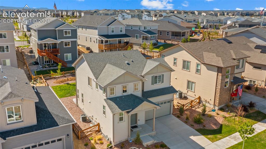 Image 31 of 38: Contemporary two-story residence featuring light siding, a dark roof, and a
