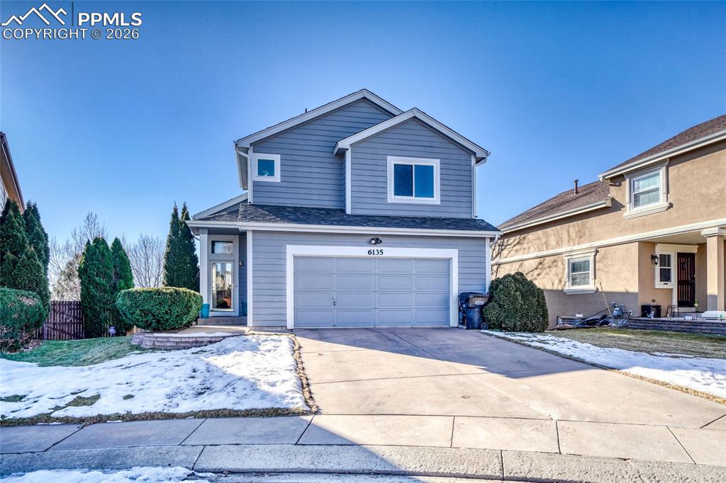 Image 1 of 46: Traditional-style home with a garage, driveway, and a shingled roof