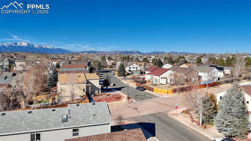 Image 39 of 46: Aerial view of residential area with a mountain backdrop
