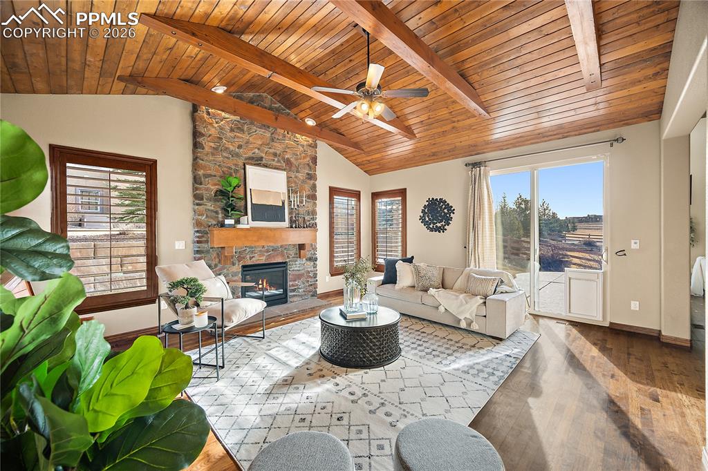 Image 4 of 29: Cozy Family room on the main level with fireplace and stunning wood ceiling