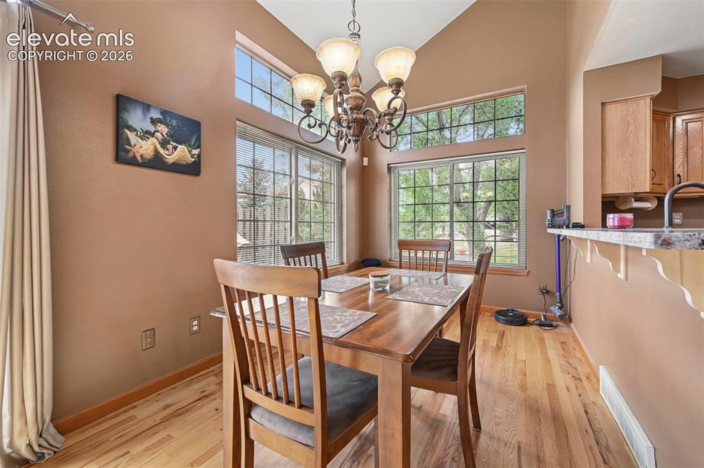 Image 13 of 50: Vaulted ceiling, wood-finish flooring, large picture windows, transom windo