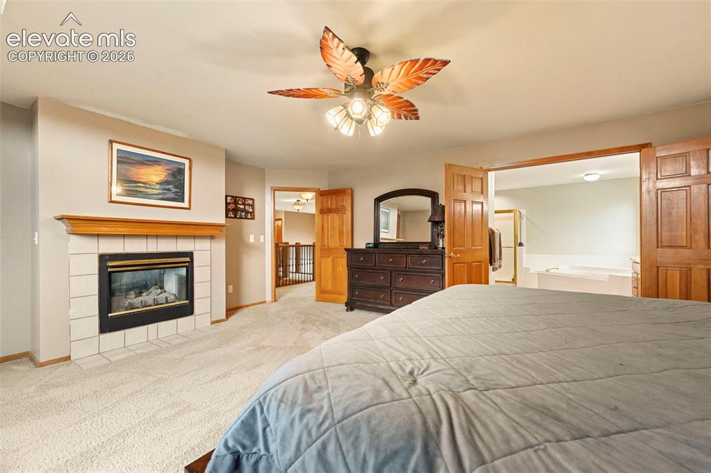 Image 20 of 50: Fireplace with tile surround and wood mantel
