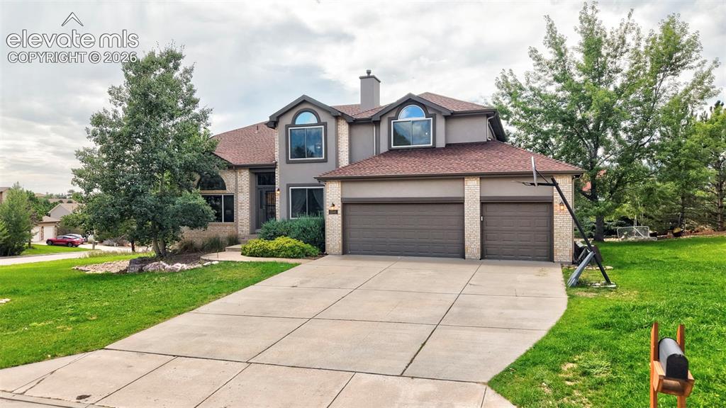 Image 40 of 50: Two-story residence with a stucco and brick exterior