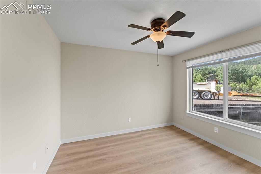 Image 17 of 38: Empty room featuring light wood-style flooring and ceiling fan