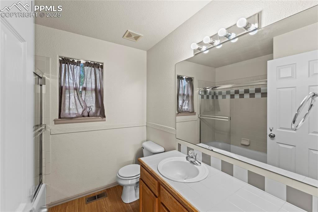 Image 19 of 38: Second Floor Full 
Bathroom featuring wood finished floors, enclosed tub /