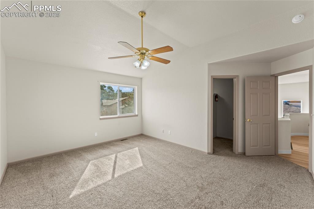 Image 24 of 38: Unfurnished bedroom featuring light colored carpet, a spacious closet, and 