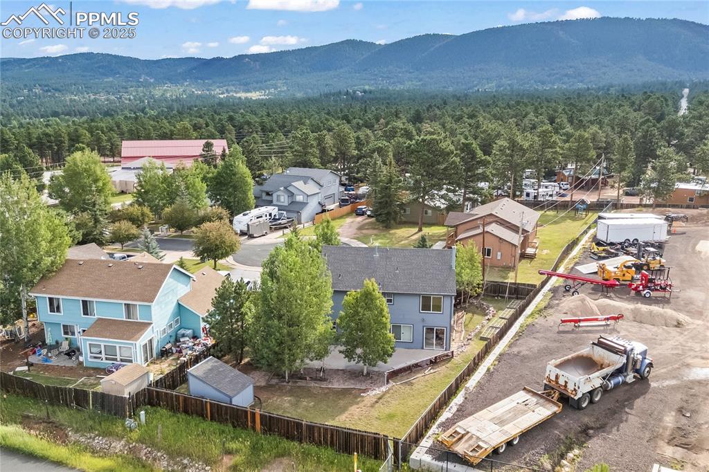 Image 35 of 38: Aerial perspective of suburban area with a mountain backdrop
