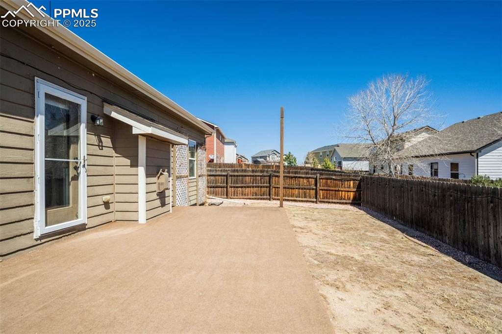 Image 45 of 47: View of yard with a fenced backyard, a residential view, and a patio area