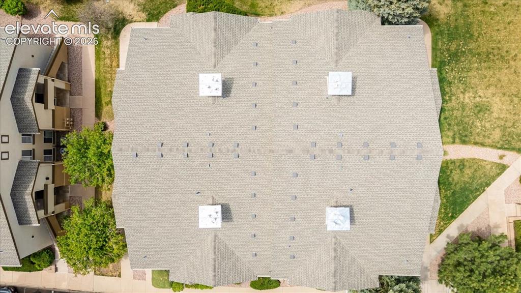 Image 39 of 39: The coverd patio looks over the open green way behind, and has its own stor