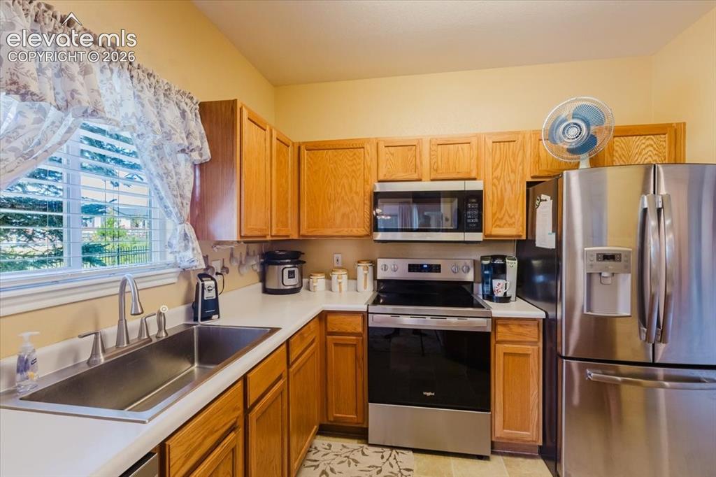 Image 8 of 39: From the front door, you look into the spacious living room with crown mold