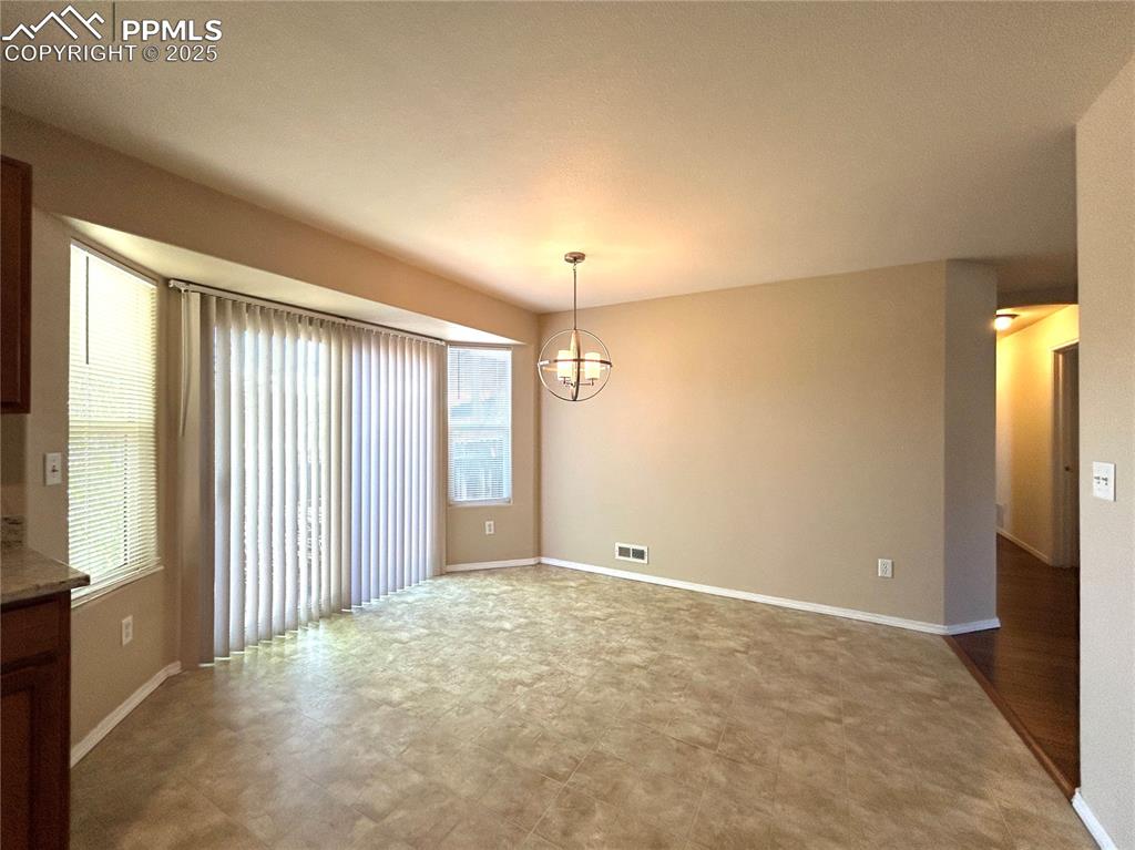 Image 13 of 43: Dining area with an inviting chandelier