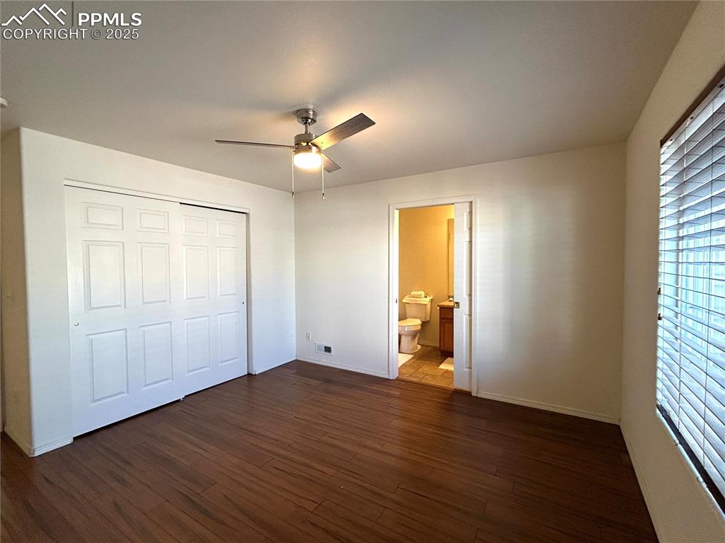 Image 15 of 43: Master bedroom featuring dark wood-style flooring, ensuite bath, a ceiling 