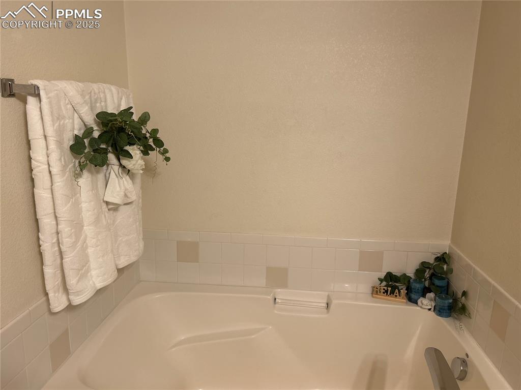 Image 18 of 43: Bathroom featuring a garden tub