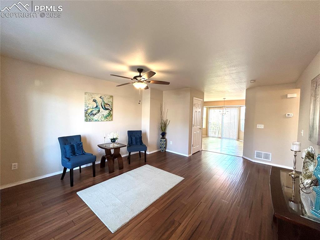Image 3 of 43: Sitting room featuring baseboards, ceiling fan with notable chandelier, dar