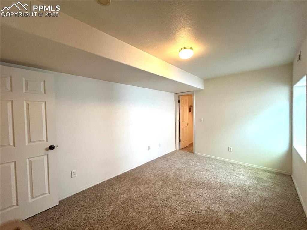Image 32 of 43: Basement featuring baseboards and carpet flooring