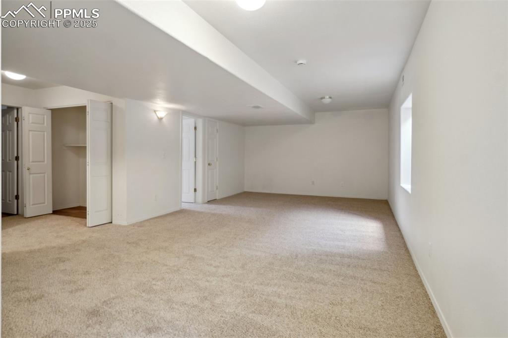 Image 34 of 43: Below grade area featuring carpet floors and baseboards