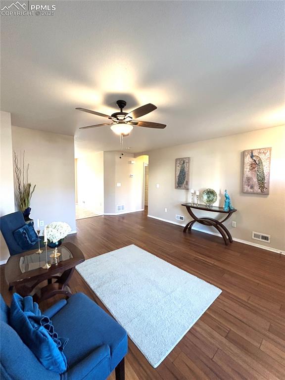 Image 4 of 43: Living room with baseboards, ceiling fan, visible vents, and wood finished 