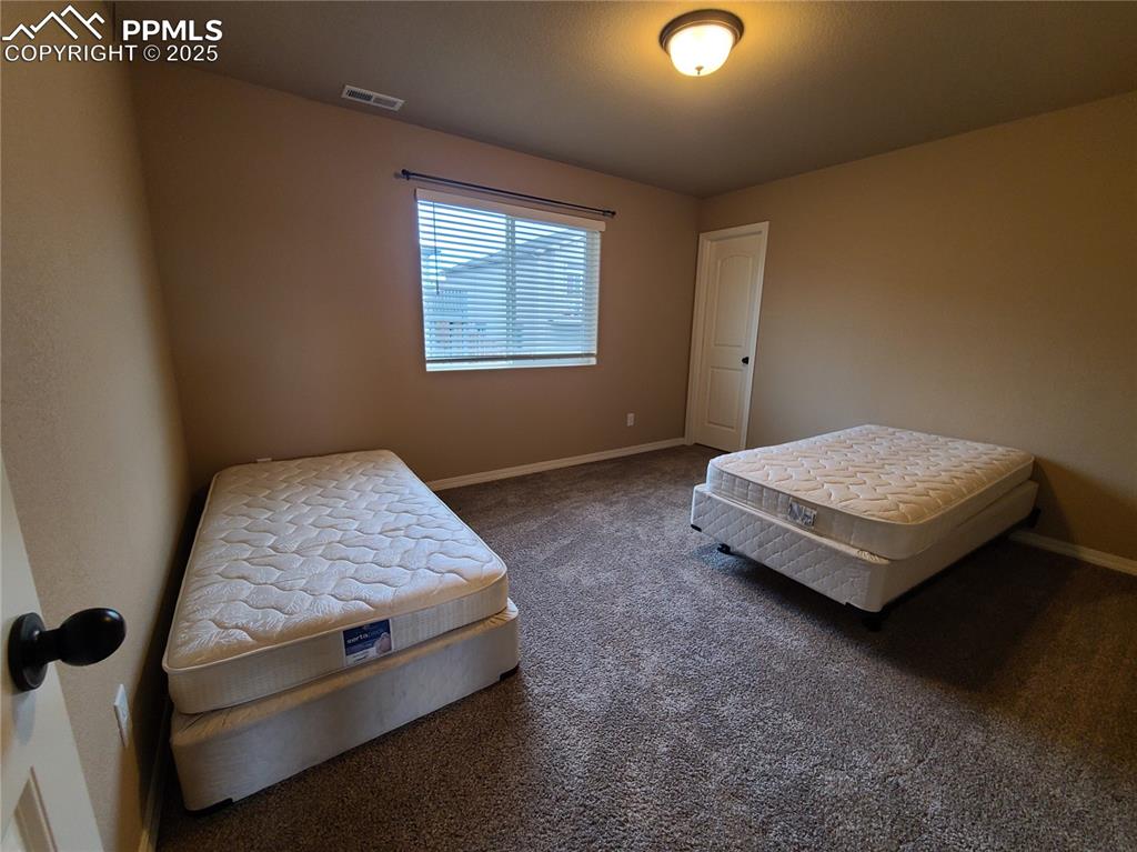 Image 24 of 29: Bedroom with carpet flooring and baseboards