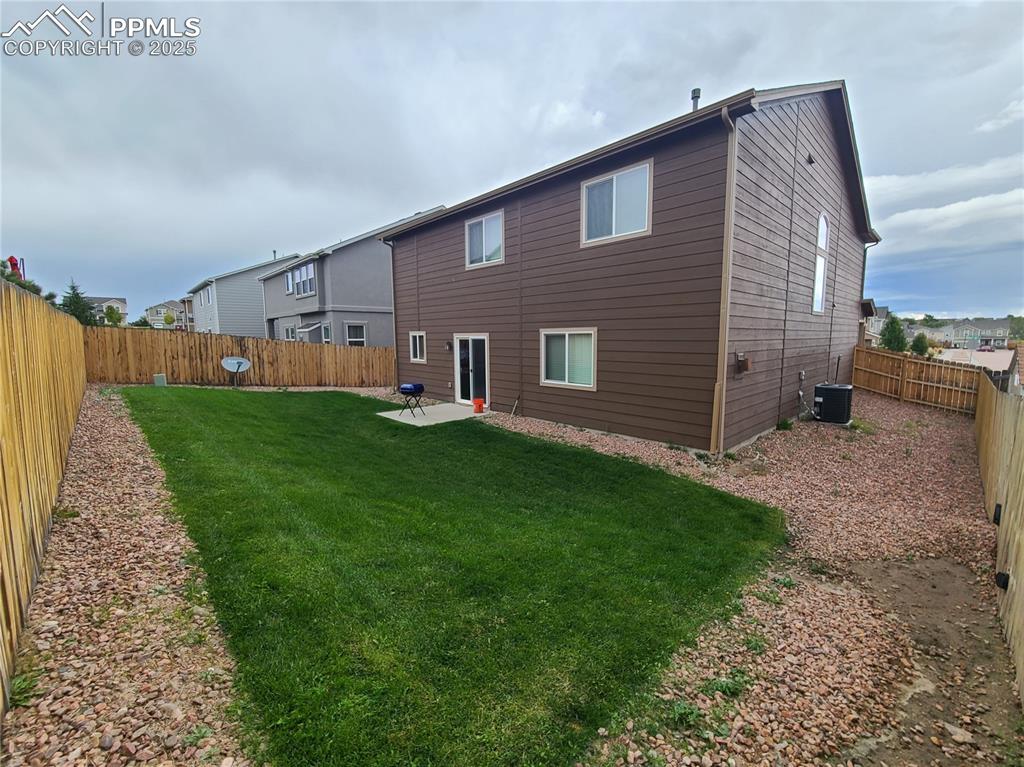 Image 29 of 29: Rear view of property with a patio and a fenced backyard
