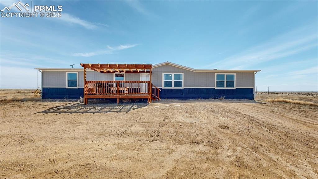 Image 2 of 40: View of front of home with a wooden deck