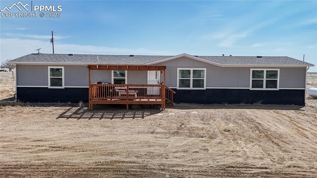 Image 38 of 40: Rear view of property with a shingled roof and a wooden deck