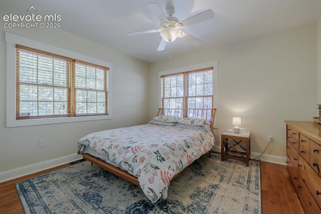 Image 12 of 49: Warm wood-finish flooring complements the neutral wall tones