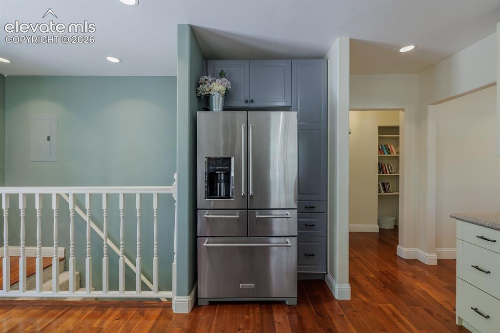 Image 26 of 49: Stainless steel French door refrigerator integrated with custom cabinetry