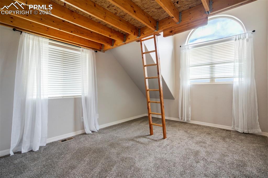Image 17 of 43: Upper level bedroom with loft