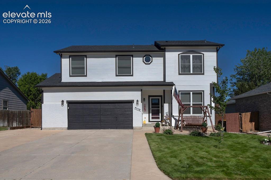 Image 1 of 30: Two-story exterior with white siding and black trim accents