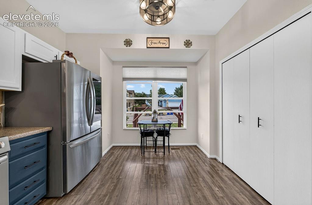 Image 11 of 30: Recessed window nook with a built-in window sill, wood-finish flooring, and