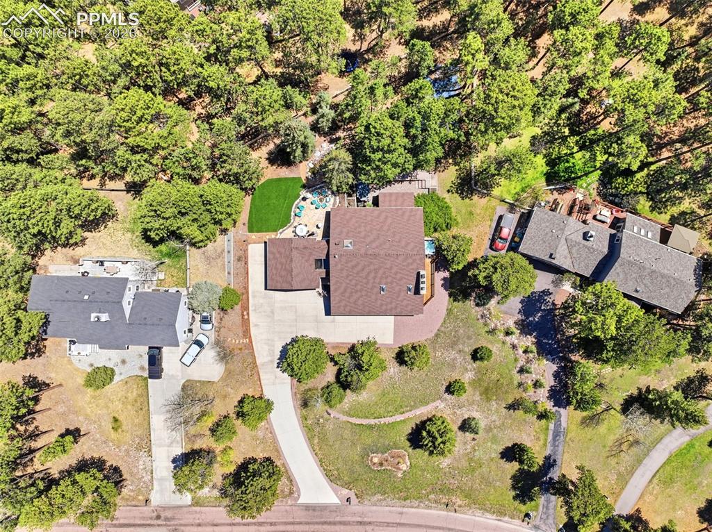 Image 50 of 50: Expansive property featuring a curved driveway, mature trees, a private dec