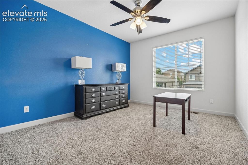 Image 18 of 39: Carpeted interior space featuring a ceiling fan with integrated lighting, a