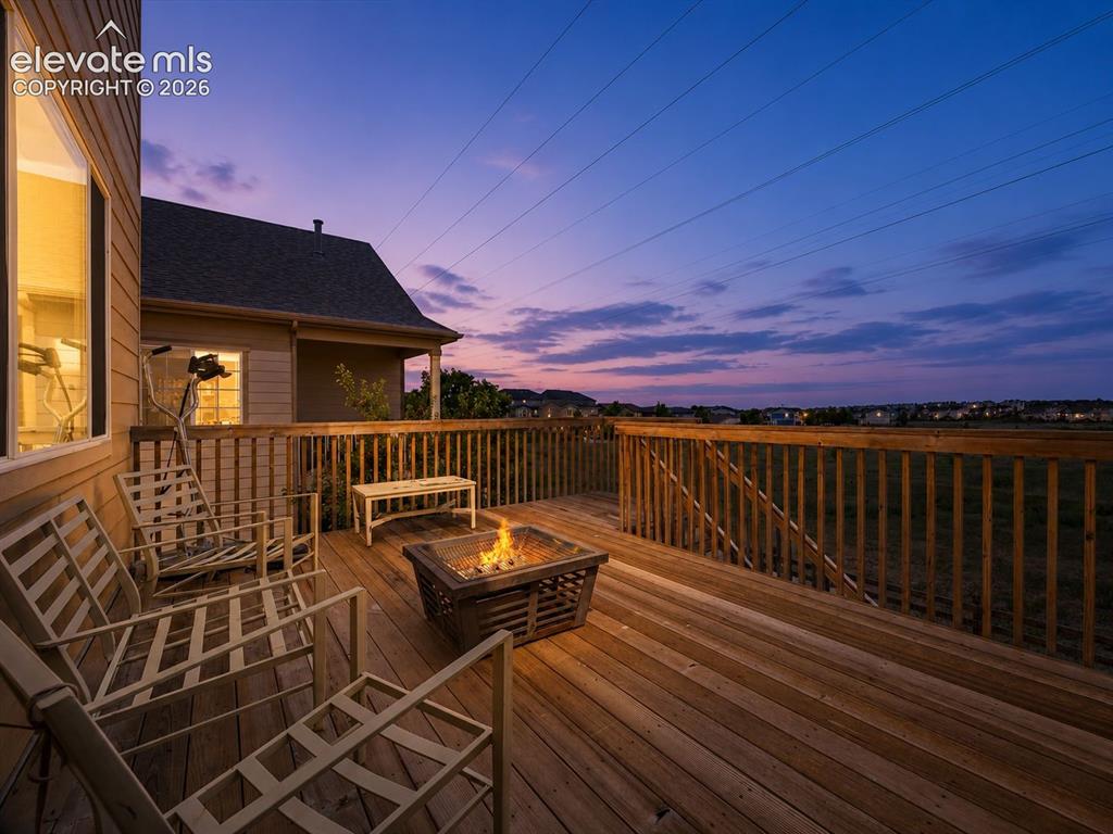 Image 25 of 39: Multi-level exterior deck with integrated staircase