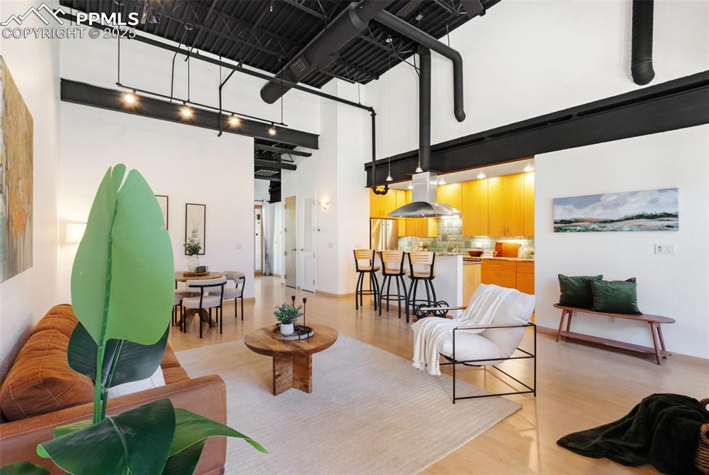 Image 4 of 38: Open floor plan of living room , dining area, and kitchen. The loft feature